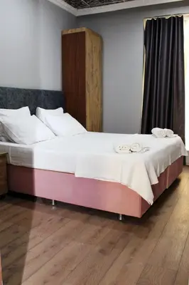 a large bed with two towels on top of it at Avist Hotel Avcılar in Avcılar