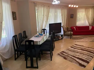 a living room with a table and chairs and a red couch at Villa Elysium in Gebze