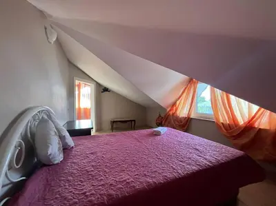a bedroom with a purple bed and a window at Villa Elysium in Gebze
