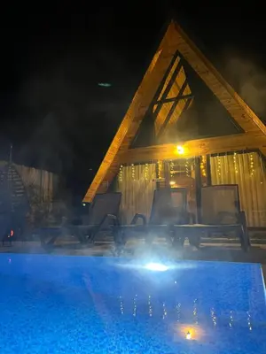 a house with a swimming pool at night at Teona Kartepe Bungalov in Kartepe