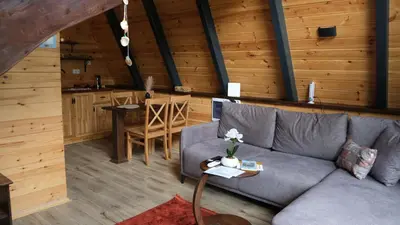 a living room with a couch and a table at Teona Kartepe Bungalov in Kartepe
