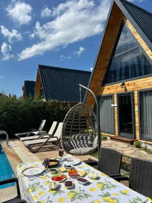 a table with plates of food on a patio at Teona Kartepe Bungalov in Kartepe