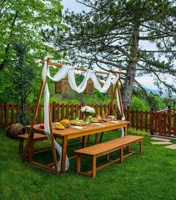 a picnic table with a white drape and a bench at Mjoraste Sapanca Boutique Villas in Sapanca
