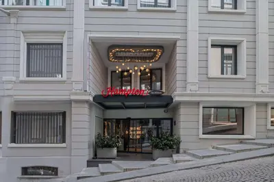 a building with a sign on the front of it at Hampton By Hilton Istanbul Sirkeci in Istanbul