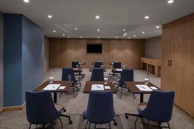 a conference room with tables and chairs and a podium at Hampton By Hilton Istanbul Sirkeci in Istanbul