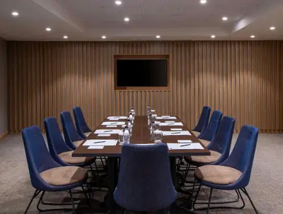 a conference room with a long table and blue chairs at Hampton By Hilton Istanbul Sirkeci in Istanbul