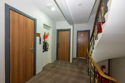 a hallway with two doors and a stairway at mayza otel in Istanbul