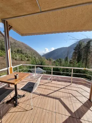 a wooden deck with a table and chairs on it at Grandvadi Villa kapalı ısıtmalı havuz in Sapanca
