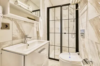 a white bathroom with a sink and a toilet at Stamboul Hotel & Suites in Istanbul