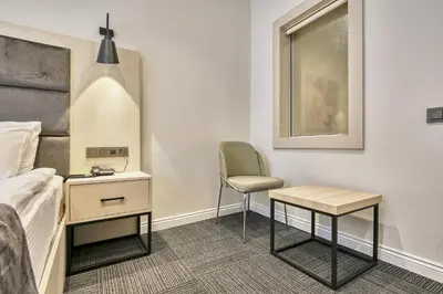 a bedroom with a bed and a desk and a chair at Stamboul Hotel & Suites in Istanbul