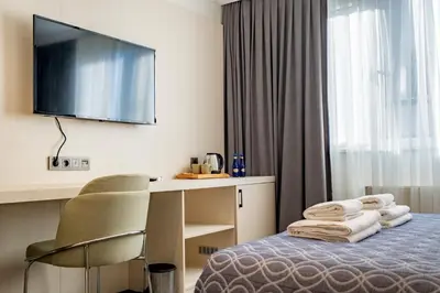 a hotel room with a bed with a desk and a television at Stamboul Hotel & Suites in Istanbul