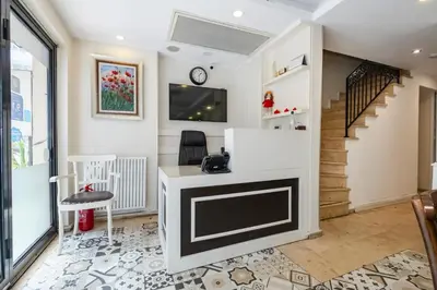a living room with a tv and a desk at Ten Rooms Istanbul Hotel in Istanbul