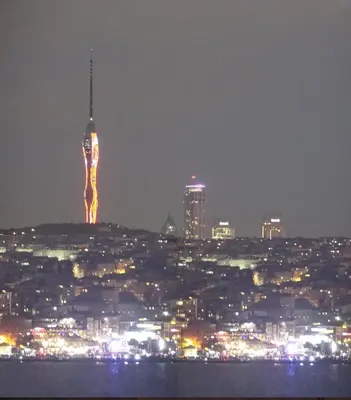 a view of a city at night with a tower at Bosphorus view-Airport shutle-High Speed WIFI-Private parking in Istanbul