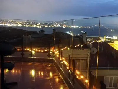 a view of a rooftop at night with lights at Bosphorus view-Airport shutle-High Speed WIFI-Private parking in Istanbul
