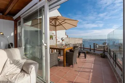 a balcony with a table and an umbrella at Bosphorus view-Airport shutle-High Speed WIFI-Private parking in Istanbul