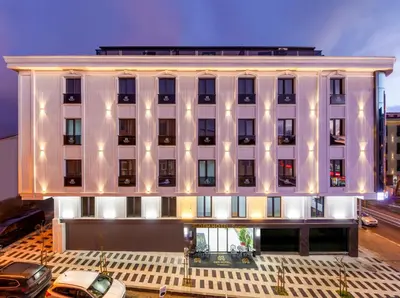 a large white building with lights on it at Dem Premium Hotel - Round Trip Airport Service - Istanbul International Airport in Arnavutköy