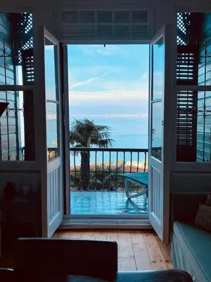 a living room with a view of the ocean at Büyükada Al Köşk in Buyukada