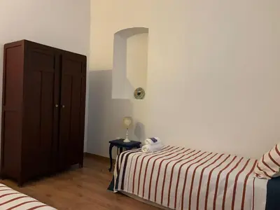 a bedroom with a bed with a striped blanket at Büyükada Al Köşk in Buyukada
