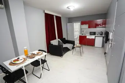 a living room and kitchen with a table and chairs at Arkem Maltepe in Istanbul