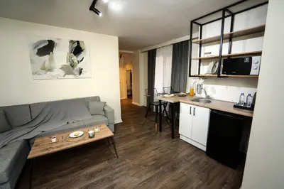 a living room with a couch and a table and a kitchen at Arkem Maltepe in Istanbul