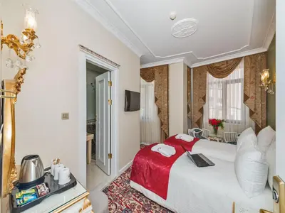 a hotel room with a bed with a red blanket at Galatower Hotel in Istanbul