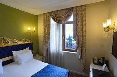 a bedroom with a bed and a window at Galatower Hotel in Istanbul