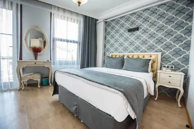 a bedroom with a large bed and a mirror at Pera Life in Istanbul