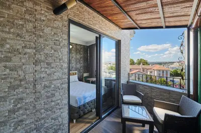 a room with a bed and a balcony with a view at Pera Life in Istanbul