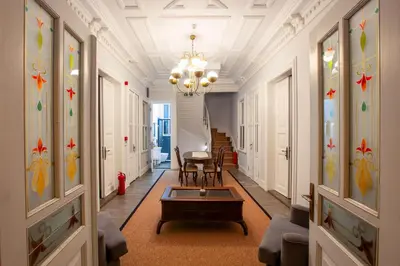 a hallway with a chandelier and a table in a building at Mansion Miliá in Adalar