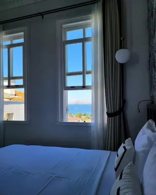a bedroom with a window with a view of the ocean at Mansion Miliá in Adalar