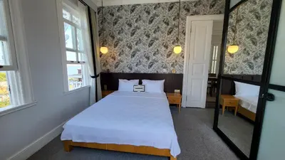 a small room with a bed and a mirror at Mansion Miliá in Adalar