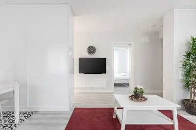 a white living room with a tv and a red rug at Bright Private Modern 2BD1Bath Bebek Gem! #247 in Istanbul