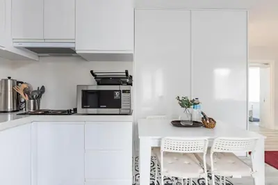 a white kitchen with a table and a microwave at Bright Private Modern 2BD1Bath Bebek Gem! #247 in Istanbul