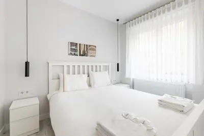 a white bedroom with a white bed and a window at Bright Private Modern 2BD1Bath Bebek Gem! #247 in Istanbul