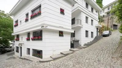 a white building with flowers in the windows at Bright Private Modern 2BD1Bath Bebek Gem! #247 in Istanbul