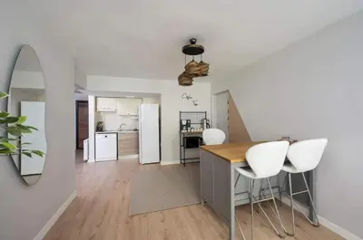 a kitchen with a table and white chairs in a room at Gorgeous Bright New 2BD Central Home! #212 in Istanbul