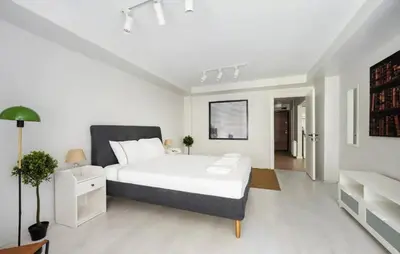a white bedroom with a large white bed and a couch at Gorgeous Bright New 2BD Central Home! #212 in Istanbul