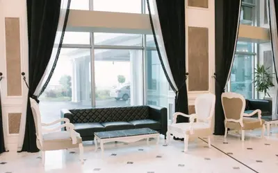a living room with a couch and chairs at Burgaz İzer Hotel in Lüleburgaz
