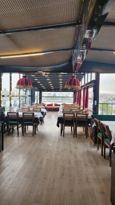 a dining room with tables and chairs and windows at Lale Sultan Hotel in Istanbul