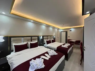 a hotel room with two beds and a table at Lale Sultan Hotel in Istanbul
