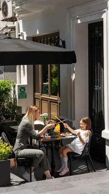 two women and a baby are sitting at a table at Nex Hotel & Spa Istanbul in Istanbul