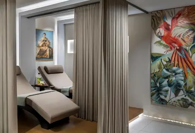 a therapy room with a massage table and a chair at Nex Hotel & Spa Istanbul in Istanbul