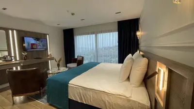 a hotel room with a bed and a television at Mona Bosphorus Hotel in Istanbul