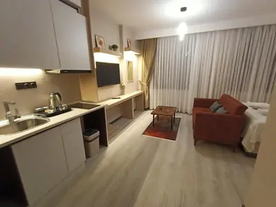 a hotel room with a kitchen and a living room at NEW FALCON PALAS OTEL in Istanbul