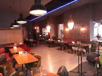 a dining room with tables and chairs and lights at NEW FALCON PALAS OTEL in Istanbul