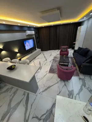 a living room with couches and a tv on a marble floor at Sapanca Villa View Suite in Sapanca