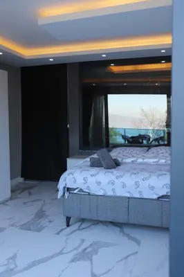 a bedroom with a bed and a large window at Sapanca Villa View Suite in Sapanca