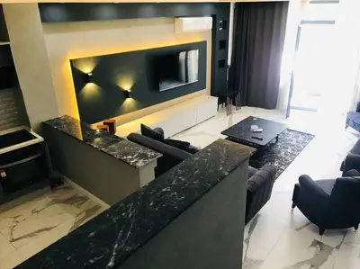 a living room with a tv on a wall with couches at Sapanca Villa View Suite in Sapanca