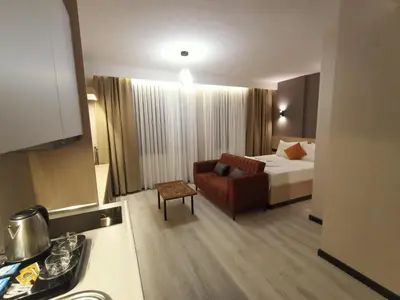 a hotel room with a bed and a couch at NEW FALCON Palas OTEL in Istanbul