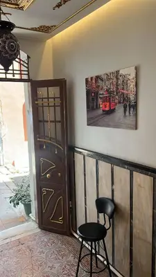 a black chair sitting next to a wall with a door at Bali Star City Hotel in Istanbul